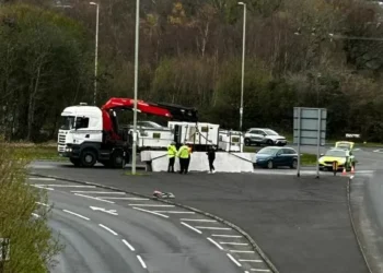 Heavy goods spilled off lorry onto busy roundabout