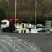 Heavy goods spilled off lorry onto busy roundabout